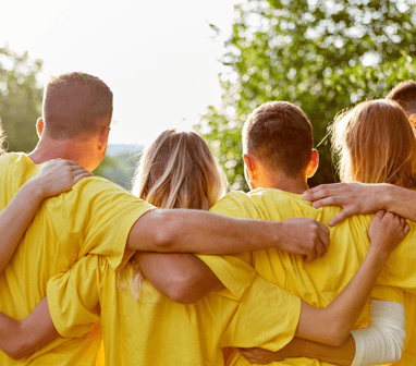 a group of people in yellow shirts and yellow shirts