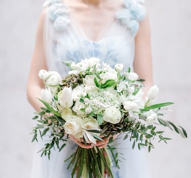 Beautiful bride in Karen Rodrigues gown holding flower bouquet