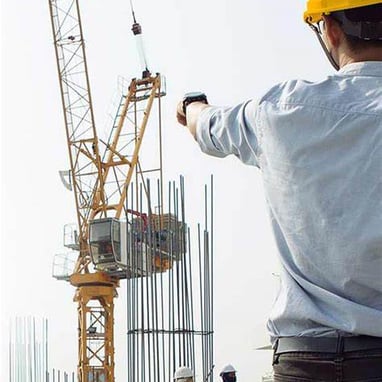 a construction worker is holding a cell phone