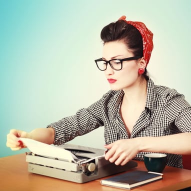 Woman wearing glasses reading a document like a detective.