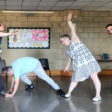 A group of people performing stretched movements