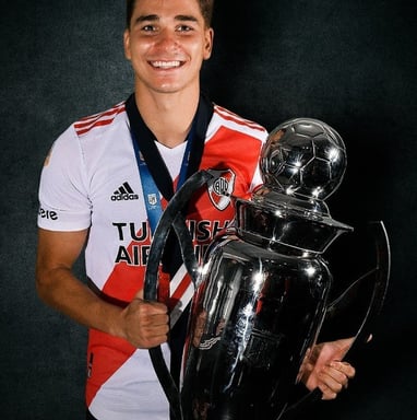 a man holding a trophy and a trophy
