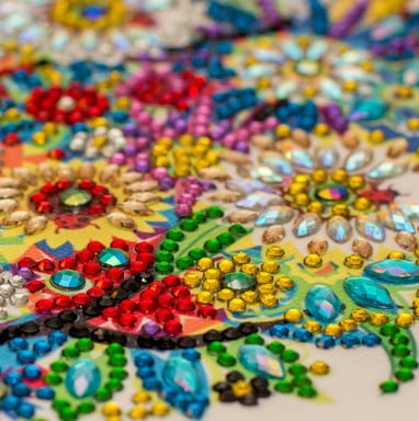 a close up of a colorful embroided rhinestone on a table