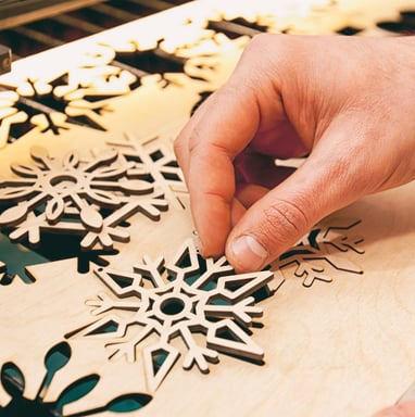 Laser cutting snowflakes from a wooden board