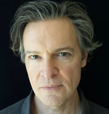 Closeup headshot of Todd Long with medium-short hair and serious expression