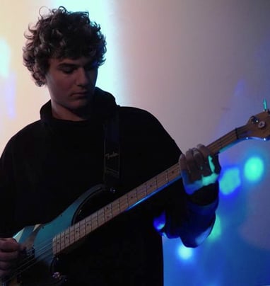 a man playing a guitar on stage
