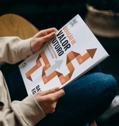 a person sitting on a chair with a book about how to write a book