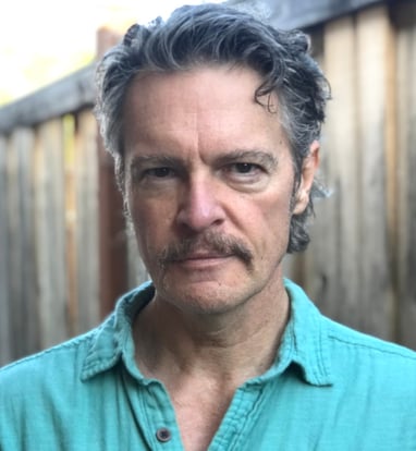 Headshot image of Todd Long with moustache