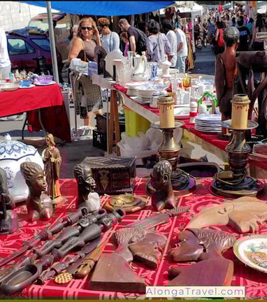 odd fun objects for sale on a table at Feira da Ladra flee market near tram 28 stop