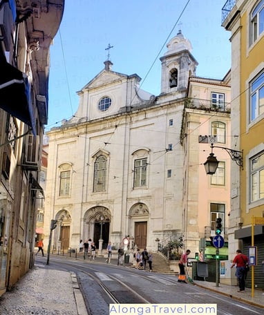 Igreja de Santa Maria Madalena with shinning tracks of Lisbon tram 28 in front of it