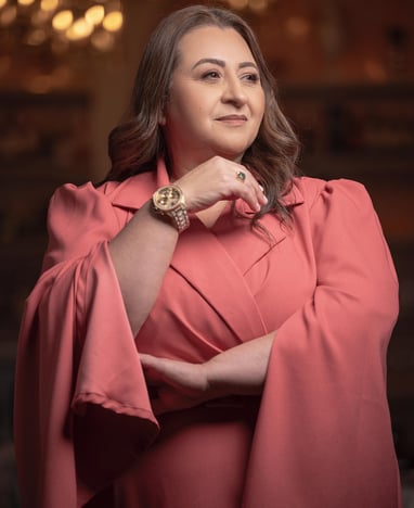 a woman in a pink dress with a watch on her wrist