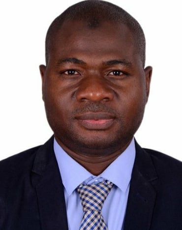 a man in a suit and tie with a blue tie