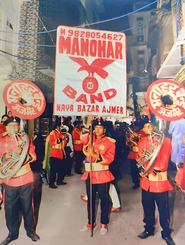An old photo showcasing the Manohar Brass Band during a roadshow for Gangaur festival.