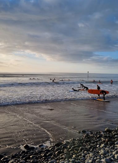A busy surf lesson at Ynyslas with clean good waves and evening sunshine