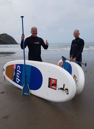 Derek the weatherman Brockway posing with paddle boards in Borth