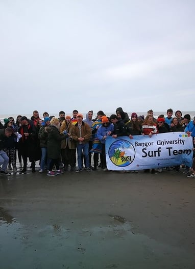 Aberystwyth and Bangor University surf clubs posing for a picture