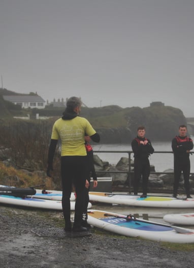 The rugby team getting intsruction from AberAdventures paddle board coaches