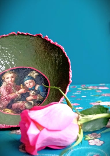 a decorative bowl with 18th century collage, vibrant colors