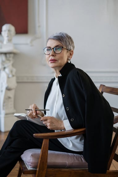 a woman sitting in a chair with a tablet