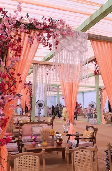 a wedding ceremony with a pink canopy tent