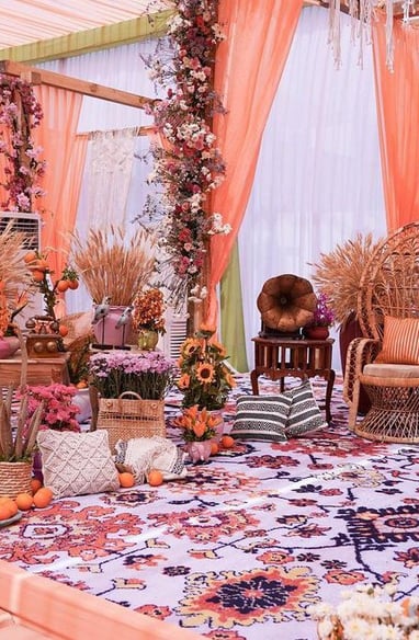 a decorated wedding ceremony with a large floral arrangement