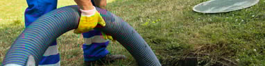 Worker pumping Septic Tank