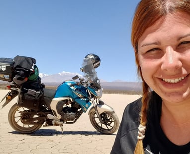 a woman in a black shirt and a blue motorcycle