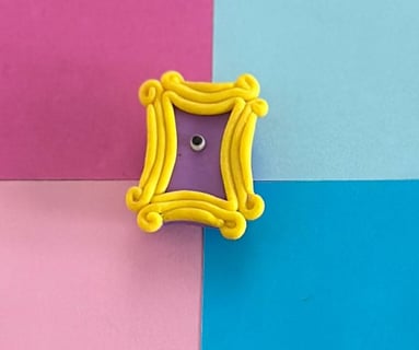 friends themed yellow door frame fridge magnet made of polymer clay with a colorful background