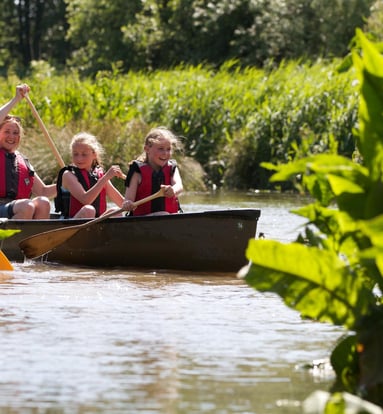 a group of people in a canoe on a river