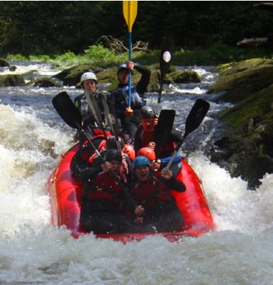 a group of people rafting down a river