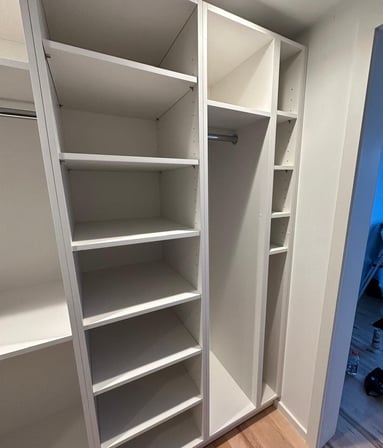 a closet with a closet door open and a closet door open