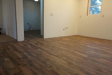 New vinyl laminate flooring was spread throughout this house in Goshen, IN, while being remodeled.