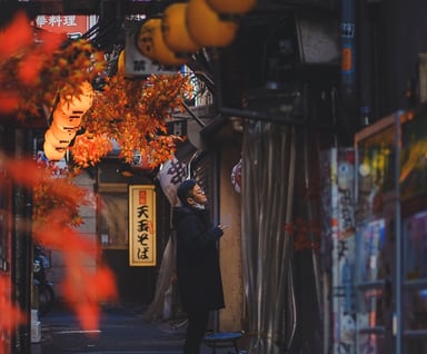 Elvin Mendoza captures the vibrant, bustling streets of Shinjuku, Tokyo where a man is smoking.