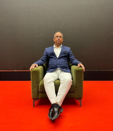 a man sitting in a chair with his feet on the floor