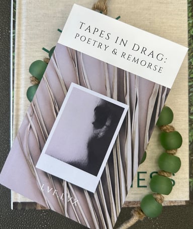 print book of tapes in drag: poetry & remorse by lvf.lvx on display with prayer beads