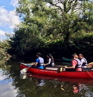 a group of people in a canoe on a river