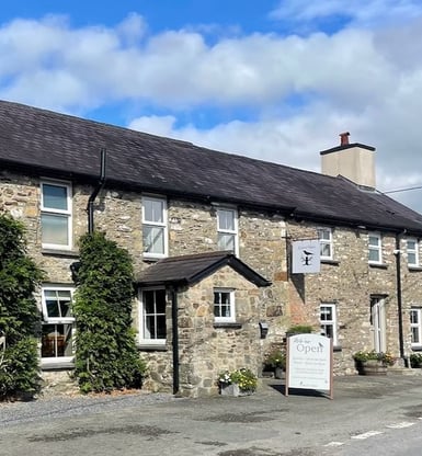 a stone building with a sign that says the name of the building