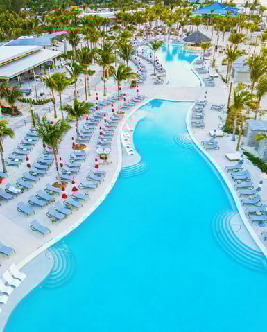 a large pool with lounge chairs and lounge chairs
