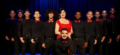 a group of people standing in front of a stage