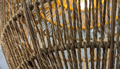 a wicker basket weave basket hanging from a wicker basket