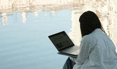 Person on laptop in the open