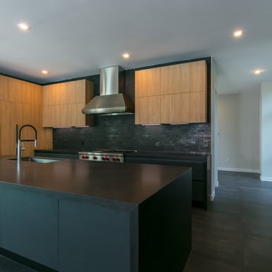 an elegant black brick and floor kitchen with a huge island countertop sace