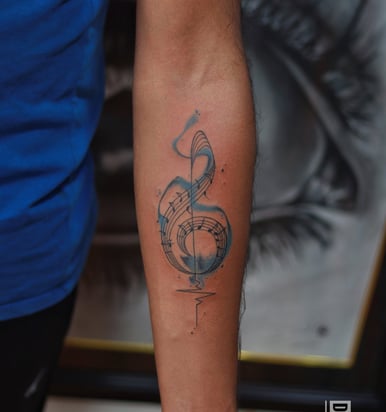 Watercolor music symbol tattoo at Dudo's Tattoos Hyderabad