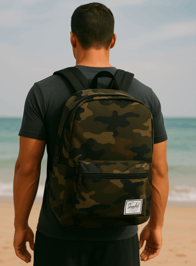 Rick Silvia wearing a camo Herschel backpack on a Thai Beach