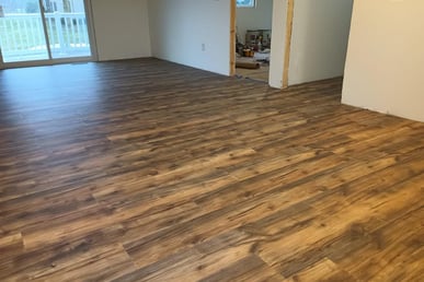 New vinyl laminate flooring was spread throughout this house in Goshen, IN, while being remodeled.