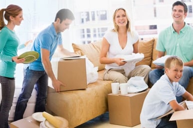 a family moving boxes in a living room