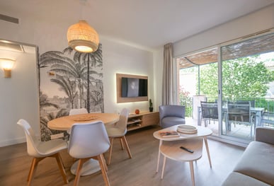 a living room with a table and chairs