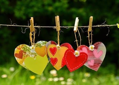 a bunch of hearts on clothes pegs on a clothes line