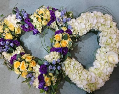 Entwined heart funeral floral display