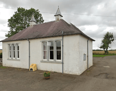 a small white village community hall